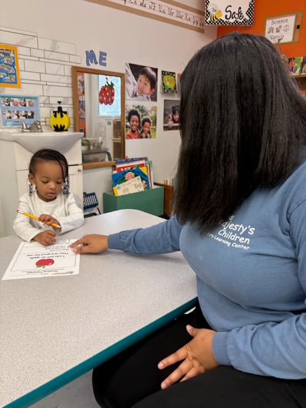 Child focused on reading and early literacy activities